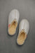 Birds Eye View of Alys Eco Sheepskin Slippers on Concrete Surface