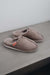 Side View of Alys Stone Sheepskin Slippers on Concrete Surface