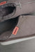 Close up View of Alys Stone Sheepskin Slippers with Heatons label detail on Concrete Surface