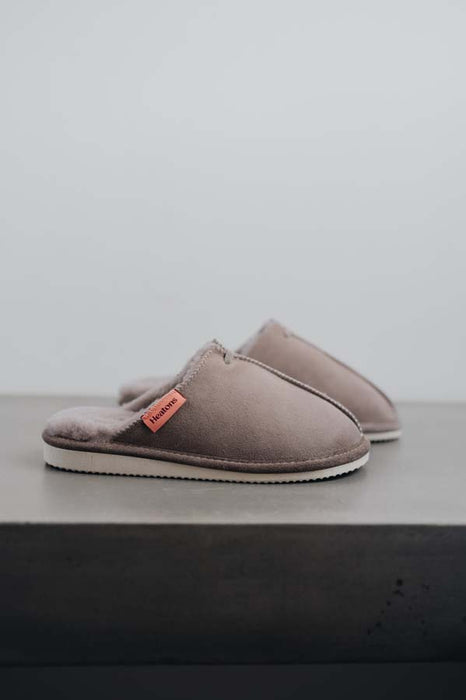 Side View of Alys Stone Sheepskin Slippers on Concrete Surface