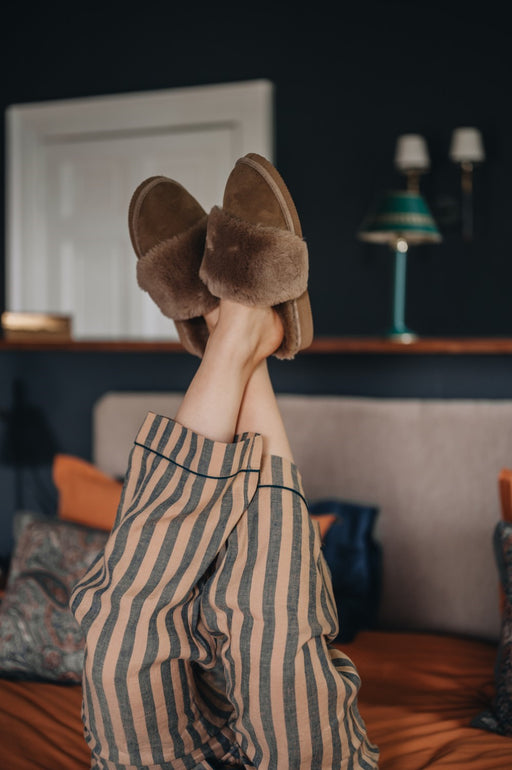 Veronica Slipper on a women's feet in the air with striped pyjama's on - warm Spanish Merino sheepskin