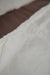 Close-up of a the rubber non
-slip underside of a white sheepskin pet bed