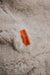 Orange cotton label with 'Heatons' branding on an oatmeal sheepskin beanbag.
