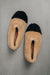 Birds eye view of ballerina style curly beige sheepskin slipper with black toe point