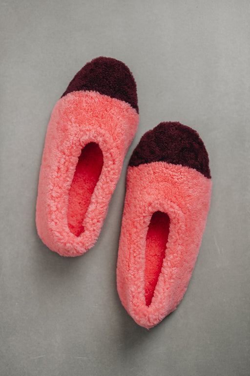 Birds eye view of ballerina style curly pink sheepskin slipper with burgundy toe point