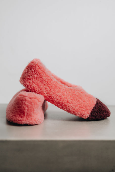 Side and rear view of soft-soled ballerina style curly beige sheepskin slipper with black toe point