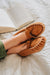 Ava Women's Real Sheepskin Moccasins worn by model with feet up on a bed reading a book 