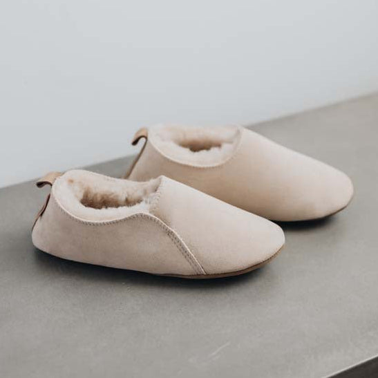 Side view of Grace - a vanilla coloured light soft-soled sheepskin slipper, that is handcrafted in Europe from the highest grade of premium Spanish merino sheepskin.