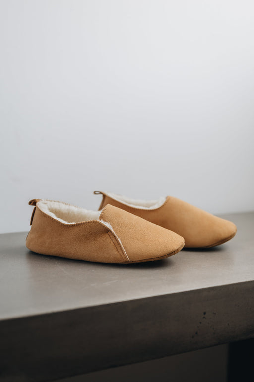 Side view of Grace - a light soft-soled sheepskin slipper, that is handcrafted in Europe from the highest grade of premium Spanish merino sheepskin.