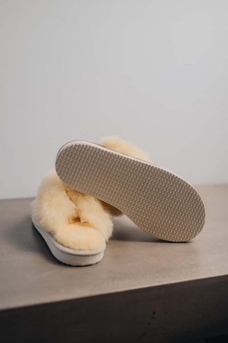 Gwen Sheepskin Slippers in Eco showing the bottom of the EVA sole on a Concrete Surface
