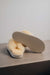 Gwen Sheepskin Slippers in Eco showing the bottom of the EVA sole on a Concrete Surface