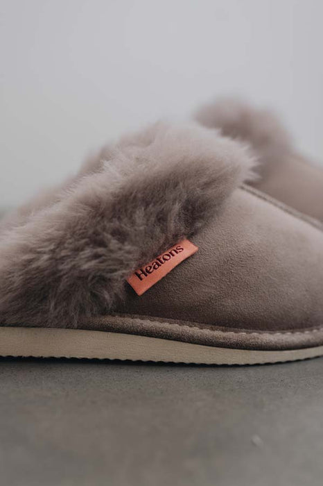 Close up View of Gwen Stone Sheepskin Slippers with Heatons label detail on Concrete Surface