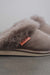 Close up View of Gwen Stone Sheepskin Slippers with Heatons label detail on Concrete Surface