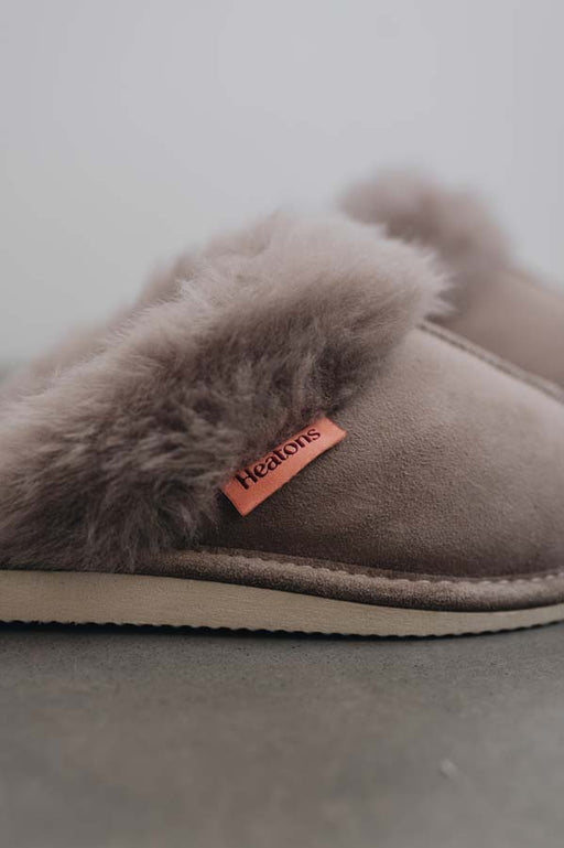 Close up View of Gwen Stone Sheepskin Slippers with Heatons label detail on Concrete Surface