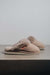 Gwen Stone Sheepskin Slippers with Heatons label detail on Concrete Surface