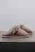 Side View of Gwen Walnut Sheepskin Slippers on Concrete Surface