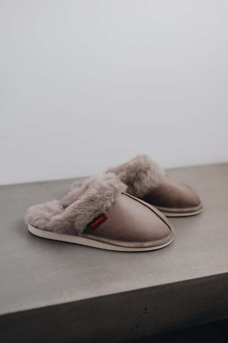 Side View of Gwen Sheepskin Slippers in Walnut on Concrete Surface