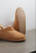 Close up of Tan coloured ankle-high sheepskin slipper showing the ribbed underside of the PVA sole