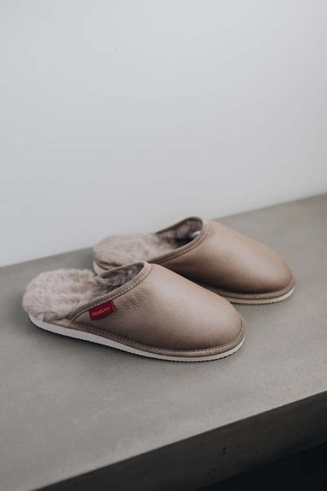 Side View of Idris Walnut Sheepskin Slippers on Concrete Surface