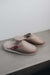 Side View of Idris Walnut Sheepskin Slippers on Concrete Surface