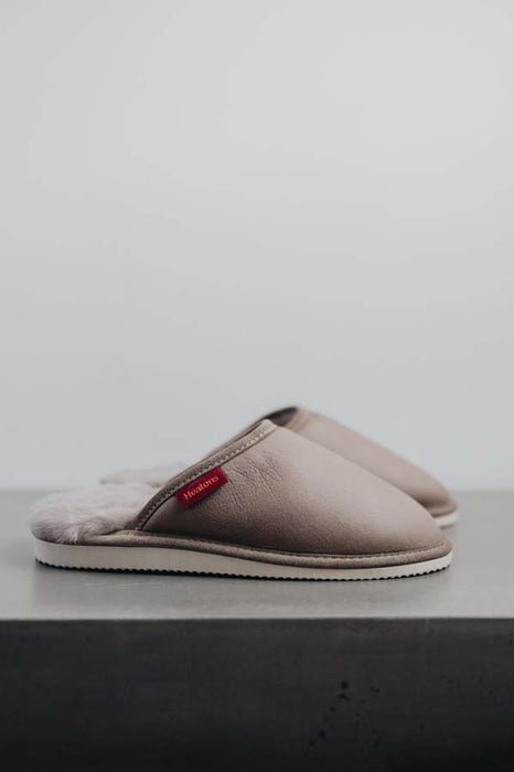 Side View of Idris Walnut Sheepskin Slippers on Concrete Surface
