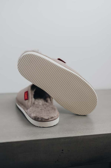Idris Walnut Sheepskin Slippers showing the bottom of the EVA sole on a Concrete Surface