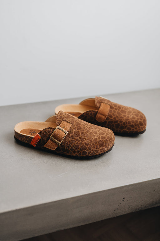 High angle of the lyra sahara clog, showing off its animal print and adjustable strap