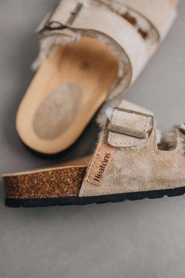 Close up on the heatons branded tag as well as the quality buckle and sheepskin strap