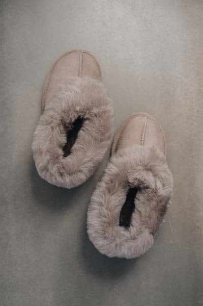 Birds Eye View of Ruby Stone Sheepskin Slippers on Concrete Surface