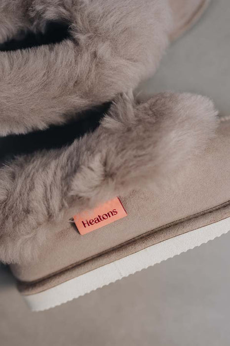 Close up View of Ruby Stone Sheepskin Slippers with Heatons label detail on Concrete Surface