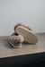 Ruby Stone Sheepskin Slippers showing the bottom of the EVA sole on a Concrete Surface