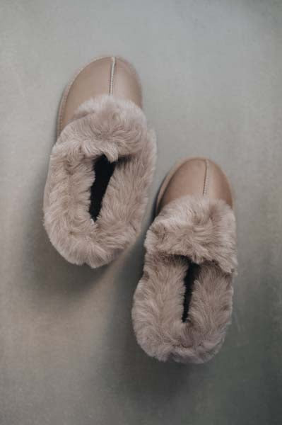 Birds Eye View of Ruby Walnut Sheepskin Slippers on Concrete Surface