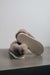 Ruby Walnut Sheepskin Slippers showing the bottom of the EVA sole on a Concrete Surface
