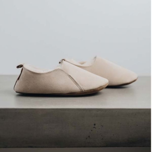 Ulla Asphalt womens sheepskin slipper by shepherd of sweden shown in front of fireplace showing soft sole