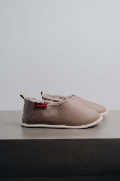 Side View of Sophia Walnut Sheepskin Slippers on Concrete Surface