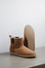 Side and bottom view of the Winnie Sheepskin, Chelsea boot style, slipper. A classic sheepskin boot with elastic panels on both sides and a rubber sole.