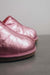 Close up View of Cadi Metallic Pink Sheepskin Slippers on Concrete Surface
