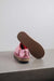 Cadi Metallic Pink Sheepskin Slippers showing the bottom of the EVA sole on a Concrete Surface