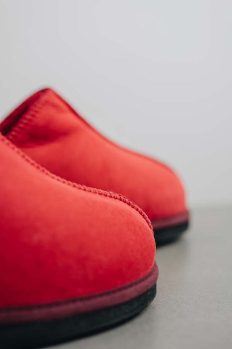 Close up View of Cadi Red Sheepskin Slippers on Concrete Surface