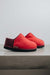 Side View of Cadi Red Sheepskin Slippers on Concrete Surface