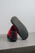 Cadi Red Sheepskin Slippers showing the bottom of the EVA sole on a Concrete Surface