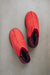 Birds Eye View of Cadi Red Sheepskin Slippers on Concrete Surface