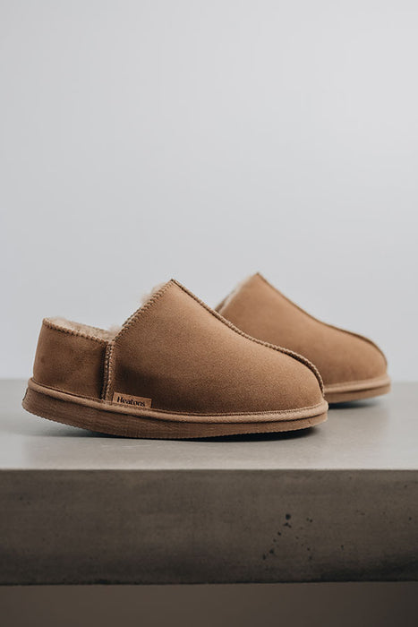 Side view of Cadi Taupe Sheepskin Slippers on Concrete Surface