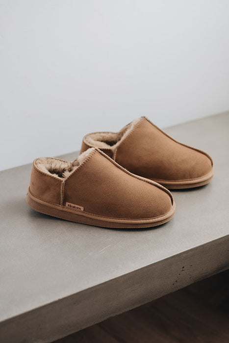 Side view of Cadi Taupe Sheepskin Slippers on Concrete Surface