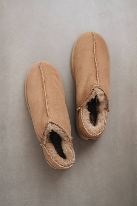 Birds eye view of Cadi Taupe Sheepskin Slippers on Concrete Surface