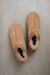 Birds eye view of Cadi Taupe Sheepskin Slippers on Concrete Surface