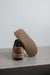 Cadi Taupe Sheepskin Slippers showing the bottom of the EVA sole on a Concrete Surface
