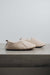 Side view of Grace - a vanilla coloured light soft-soled sheepskin slipper, that is handcrafted in Europe from the highest grade of premium Spanish merino sheepskin.