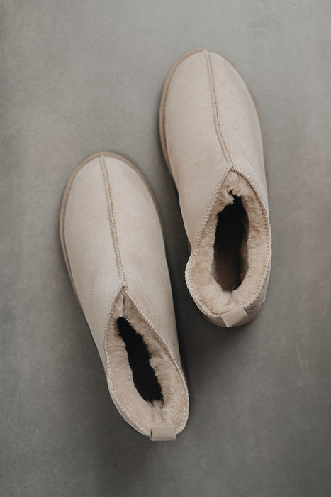 Birds eye view of Henry ankle-high sheepskin slipper showing plush natural sheepskin wool inside