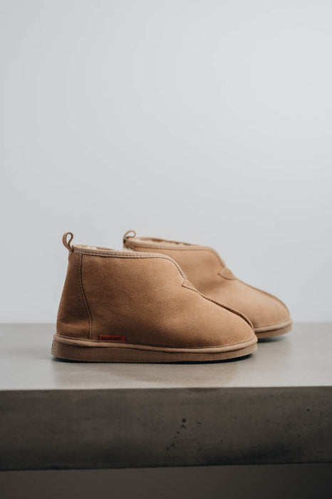Side view of Noah Tabac Sheepskin Slippers on Concrete Surface